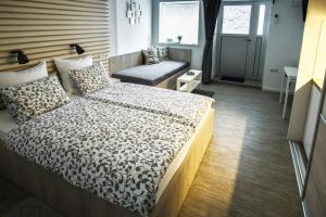 a bedroom with a bed and a bench in it at Apartment Be My Guest in Zagreb