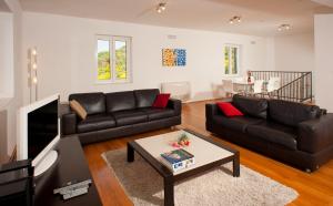 a living room with a couch and a table at Villa Apartments Mecajac in Cavtat