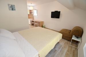 TV a/nebo společenská místnost v ubytování Guesthouse Grotta Di Nicola