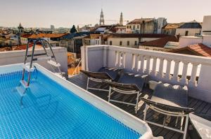 a balcony with chairs and a swimming pool at Rivoli Cinema Hostel in Porto