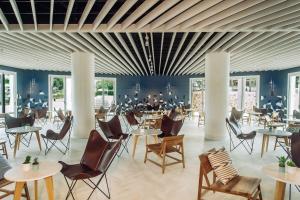 a dining room filled with tables and chairs at Inturotel Cala Esmeralda Beach Hotel & Spa - Adults Only in Cala d´Or