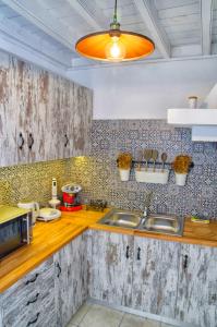 a kitchen with a sink and a microwave at Lindos Tholos Villa in Líndos