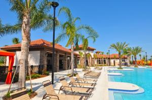 una piscina en el complejo con sillas y palmeras en Solterra Resort #230759 Home, en Davenport