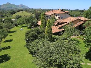 an aerial view of a house with a yard with trees at La Casina de la Arquera in Llanes