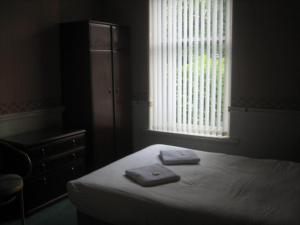 a bedroom with a bed and a window at Murrayfield Park Guest House in Edinburgh