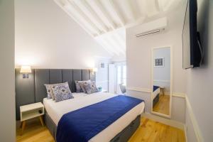 a hotel room with a bed and a window at Villa Baixa - Lisbon Luxury Apartments in Lisbon
