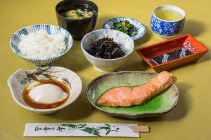 a table topped with bowls of food and rice at Suzukisou in Kyoto