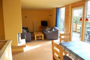 a living room with a couch and a table at Ferien im Gutspark Schwarbe mit Re in Mattchow