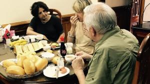 a group of people sitting around a table with food at Royal Hotel Ha Giang in Ha Giang