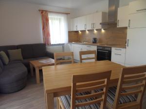 a kitchen and living room with a couch and a table at Ferienhof am Mitterberg in Bad Birnbach