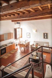 a living room with a table and a kitchen at Appartamenti Ruggini in Florence
