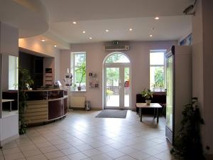 an empty lobby with an open door to a room at Hotel Vilmaja in Riga