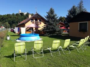 a group of chairs sitting in the grass at Sportcentrum Dvořák in Hluboká nad Vltavou