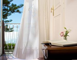 a door with a book on a desk with a window at Romantic Hotel & Restaurant Villa Cheta Elite in Maratea