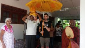 a man holding an umbrella in a group of people at Peacock Residence & Cabana's in Tangalle