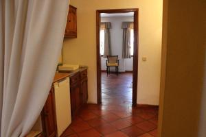 a kitchen with a door leading to a dining room at Quinta do Valle in Tomar