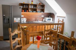 a kitchen with a table and a refrigerator at Vila Pod Bránou in Poprad