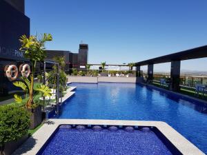 a swimming pool on the roof of a building at Dña Monse Hotel Spa & Golf in Torrevieja