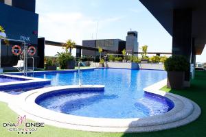 a swimming pool with a pool table and chairs at Dña Monse Hotel Spa & Golf in Torrevieja