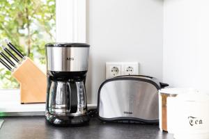 a kitchen counter with a blender and a toaster at Klara's Farm Holidays in Hella