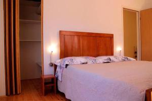 a bedroom with a bed with a wooden headboard at Casa Eufemia in Marasi