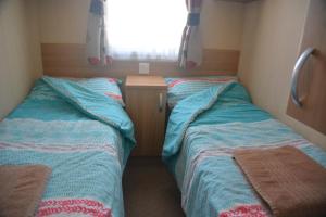 A bed or beds in a room at Weymouth Family Caravans