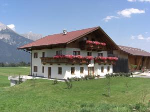 Una casa en una colina con flores. en Ferienwohnung Prader, en Innsbruck