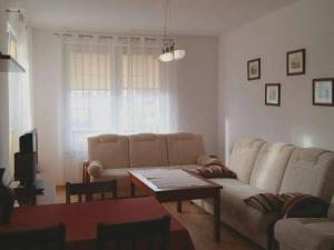 a living room with a couch and a table at Apartament Jula in Grzybowo