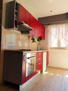 a kitchen with red cabinets and a stove at Apartment Lovre in Split
