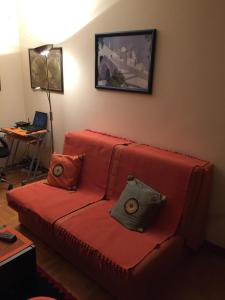 a living room with a red couch with two pillows at Apartment Linda in Zlatibor