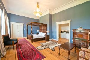 a room with a bed and a zebra rug at Schloss Retzow Apartments in Retzow