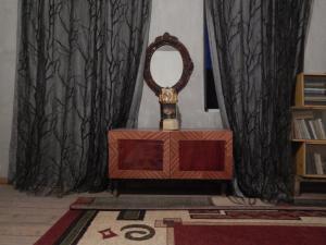 a room with a table with a clock on it at Nato Gesthouse in Uraveli in Akhaltsikhe