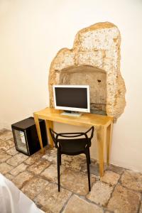 Televízia a/alebo spoločenská miestnosť v ubytovaní B&B Palazzo del Capitolo - By I Bastioni San Domenico