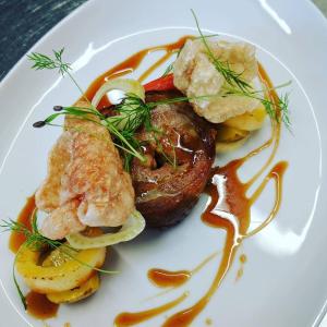 a plate of food with meat and potatoes and sauce at Mingarry Park in Acharacle +23 photos