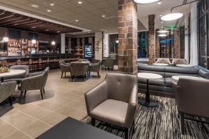 a restaurant with tables and chairs and a bar at Hyatt Place Boise/Downtown in Boise