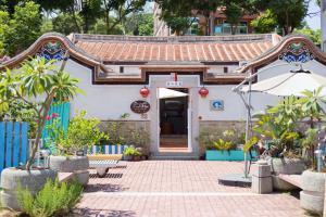 a small white building with a red roof at Naya"s Homestay in Jincheng