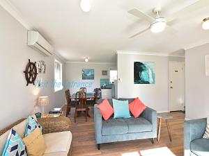 a living room with a couch and a table at The Nautical House in The Entrance