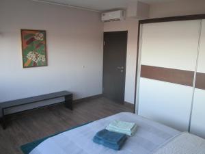 A bed or beds in a room at Genex Apartment