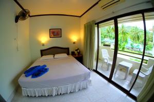 a bedroom with a large bed and a balcony at P.K. Mansion in Ao Nang Beach