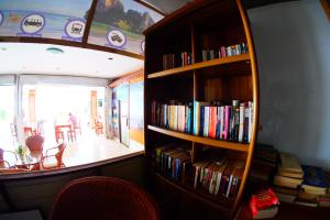 a book shelf filled with books in a room at P.K. Mansion in Ao Nang Beach