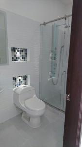 a bathroom with a toilet and a glass shower at Casa Quinta Santana in Melgar