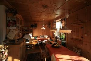 a living room with a table and a dining room at B&B Ciasa Weber in Moena