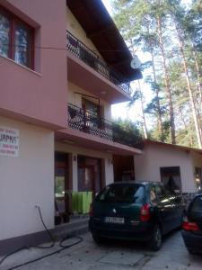a car parked in front of a building at Family Hotel Shisharka in Batak