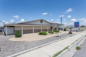 a house with a gravel driveway in front of it at Motel 6-Lordsburg, NM in Lordsburg