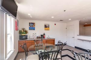 a kitchen and dining room with a table and chairs at Motel 6-Azle, TX in Azle