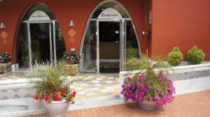 a building with potted plants in front of a building at Hotel Spa Pinar del Mar in Platja  d'Aro +83 photos