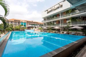 a large swimming pool in front of a building at Hotel Somadevi Angkor Boutique and Resort in Siem Reap