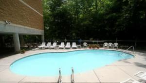 a large swimming pool with chairs and a building at Park Place Condos in Gatlinburg