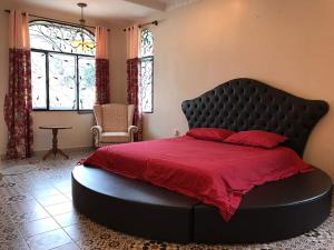 a bedroom with a large bed with a red blanket at Golden Hill in Cameron Highlands