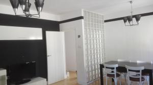 a dining room with a table and a television at VuT Dalia 4 in Ávila